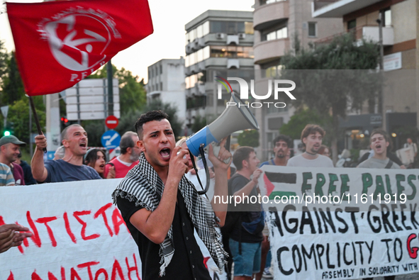 Demonstrators hold banners and flags outside the Israeli Embassy protesting against the Israeli strikes in Lebanon and the ongoing war in Ga...