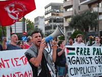 Demonstrators hold banners and flags outside the Israeli Embassy protesting against the Israeli strikes in Lebanon and the ongoing war in Ga...