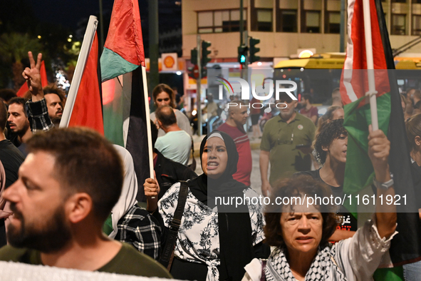 Demonstrators wave flags and chant slogans outside the Israeli Embassy protesting against the Israeli strikes in Lebanon and the ongoing war...