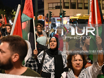 Demonstrators wave flags and chant slogans outside the Israeli Embassy protesting against the Israeli strikes in Lebanon and the ongoing war...