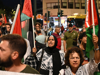 Demonstrators wave flags and chant slogans outside the Israeli Embassy protesting against the Israeli strikes in Lebanon and the ongoing war...