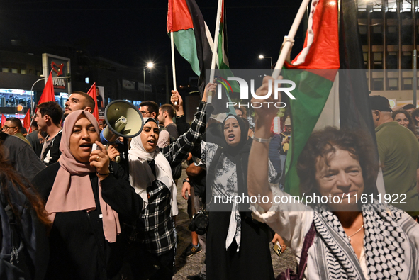 Demonstrators wave flags and chant slogans outside the Israeli Embassy protesting against the Israeli strikes in Lebanon and the ongoing war...