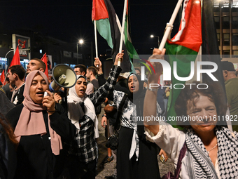 Demonstrators wave flags and chant slogans outside the Israeli Embassy protesting against the Israeli strikes in Lebanon and the ongoing war...