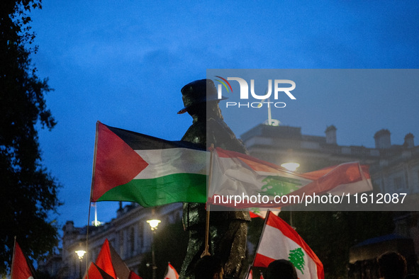 Lebanese and Palestinian flags display together during a Lebanon Ceasefire Protest at 10 Downing Street in London, United Kingdom, on Septem...