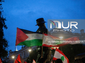 Lebanese and Palestinian flags display together during a Lebanon Ceasefire Protest at 10 Downing Street in London, United Kingdom, on Septem...