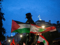 Lebanese and Palestinian flags display together during a Lebanon Ceasefire Protest at 10 Downing Street in London, United Kingdom, on Septem...