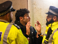 A protester is arrested by two Metropolitan Police officers during the Lebanon Ceasefire Protest at 10 Downing Street in London, England, on...