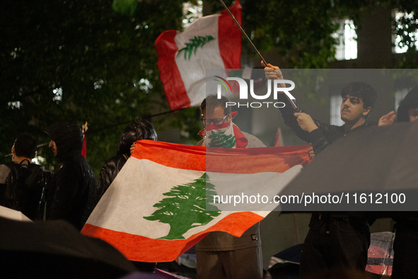 Protesters wave Lebanese flags during the Lebanon Ceasefire Protest at 10 Downing Street in London, England, on September 26, 2024. 