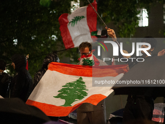 Protesters wave Lebanese flags during the Lebanon Ceasefire Protest at 10 Downing Street in London, England, on September 26, 2024. (