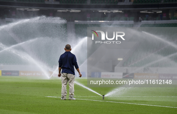 Sprinklers water the pitch inside Al Thumama Stadium before the Ooredoo Qatar Stars League 24/25 match between Al Rayyan SC and Al Arabi SC...