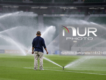 Sprinklers water the pitch inside Al Thumama Stadium before the Ooredoo Qatar Stars League 24/25 match between Al Rayyan SC and Al Arabi SC...