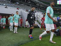 Al Rayyan SC and Al Arabi SC players walk onto the pitch before the Ooredoo Qatar Stars League 24/25 match between Al Rayyan SC and Al Arabi...