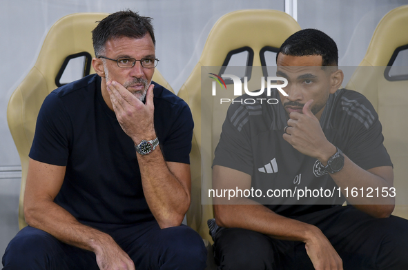 Anthony Patrick Hudson (L), head coach of Al Arabi SC, looks on before the Ooredoo Qatar Stars League 24/25 match between Al Rayyan SC and A...