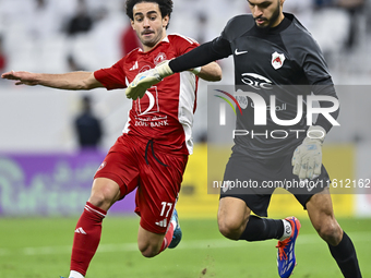 Sami Beldi (R) of Al Rayyan SC battles for the ball with Ahmed Alaaeildin Abdelmotaal (L) of Al Arabi SC during the Ooredoo Qatar Stars Leag...