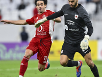 Sami Beldi (R) of Al Rayyan SC battles for the ball with Ahmed Alaaeildin Abdelmotaal (L) of Al Arabi SC during the Ooredoo Qatar Stars Leag...