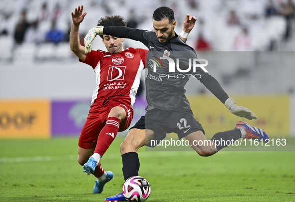 Sami Beldi (R) of Al Rayyan SC battles for the ball with Ahmed Alaaeildin Abdelmotaal (L) of Al Arabi SC during the Ooredoo Qatar Stars Leag...