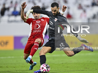 Sami Beldi (R) of Al Rayyan SC battles for the ball with Ahmed Alaaeildin Abdelmotaal (L) of Al Arabi SC during the Ooredoo Qatar Stars Leag...