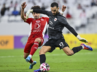 Sami Beldi (R) of Al Rayyan SC battles for the ball with Ahmed Alaaeildin Abdelmotaal (L) of Al Arabi SC during the Ooredoo Qatar Stars Leag...