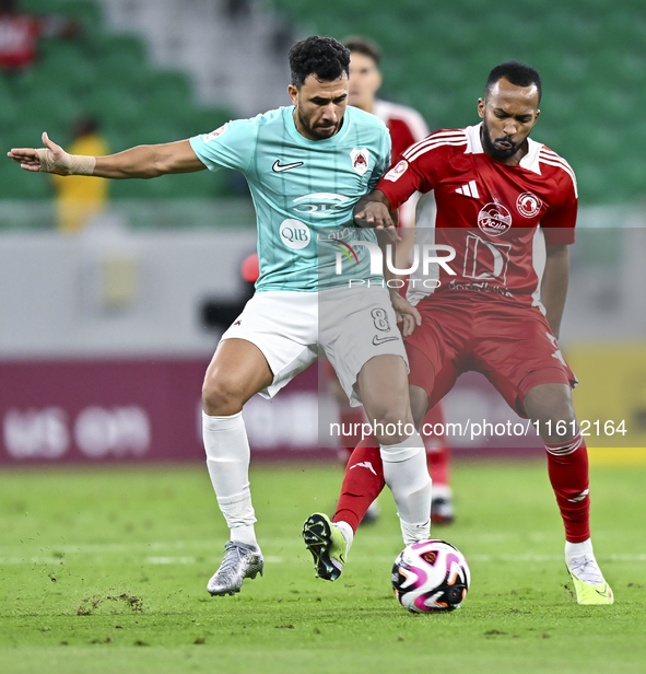 Mahmoud Hassan (L) of Al Rayyan SC battles for the ball with Ahmed Fathi Abdoulla (R) of Al Arabi SC during the Ooredoo Qatar Stars League 2...