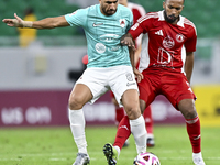 Mahmoud Hassan (L) of Al Rayyan SC battles for the ball with Ahmed Fathi Abdoulla (R) of Al Arabi SC during the Ooredoo Qatar Stars League 2...