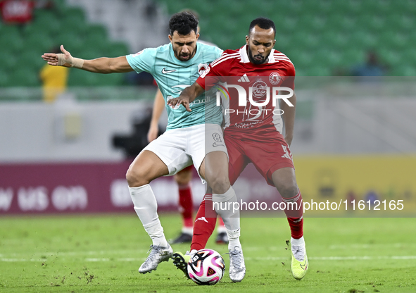 Mahmoud Hassan (L) of Al Rayyan SC battles for the ball with Ahmed Fathi Abdoulla (R) of Al Arabi SC during the Ooredoo Qatar Stars League 2...