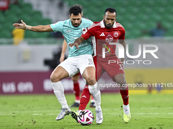 Mahmoud Hassan (L) of Al Rayyan SC battles for the ball with Ahmed Fathi Abdoulla (R) of Al Arabi SC during the Ooredoo Qatar Stars League 2...