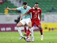 Mahmoud Hassan (L) of Al Rayyan SC battles for the ball with Ahmed Fathi Abdoulla (R) of Al Arabi SC during the Ooredoo Qatar Stars League 2...