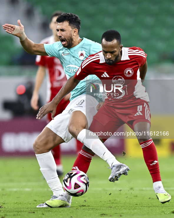 Mahmoud Hassan (L) of Al Rayyan SC battles for the ball with Ahmed Fathi Abdoulla (R) of Al Arabi SC during the Ooredoo Qatar Stars League 2...