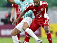 Mahmoud Hassan (L) of Al Rayyan SC battles for the ball with Ahmed Fathi Abdoulla (R) of Al Arabi SC during the Ooredoo Qatar Stars League 2...