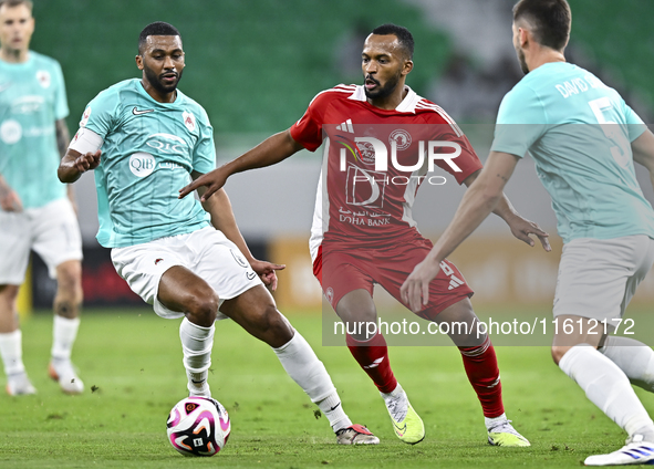 Abdel Aziz Hatim of Al Rayyan SC battles for the ball with Ahmed Fathi Abdoulla of Al Arabi SC during the Ooredoo Qatar Stars League 24/25 m...