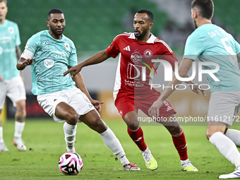 Abdel Aziz Hatim of Al Rayyan SC battles for the ball with Ahmed Fathi Abdoulla of Al Arabi SC during the Ooredoo Qatar Stars League 24/25 m...