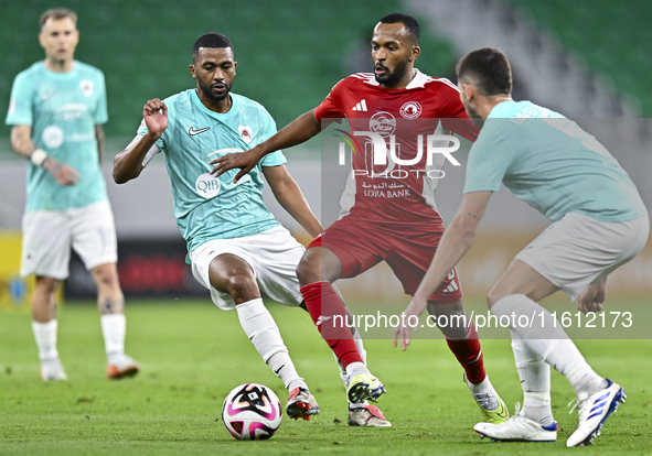 Abdel Aziz Hatim of Al Rayyan SC battles for the ball with Ahmed Fathi Abdoulla of Al Arabi SC during the Ooredoo Qatar Stars League 24/25 m...