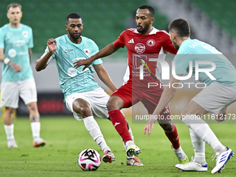 Abdel Aziz Hatim of Al Rayyan SC battles for the ball with Ahmed Fathi Abdoulla of Al Arabi SC during the Ooredoo Qatar Stars League 24/25 m...