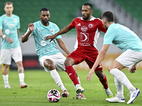 Abdel Aziz Hatim of Al Rayyan SC battles for the ball with Ahmed Fathi Abdoulla of Al Arabi SC during the Ooredoo Qatar Stars League 24/25 m...