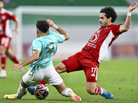 Hazem Ahmed Shehata (L) of Al Rayyan SC battles for the ball with Ahmed Alaaeildin Abdelmotaal (R) of Al Arabi SC during the Ooredoo Qatar S...