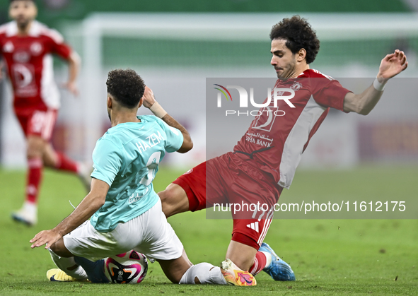 Hazem Ahmed Shehata (L) of Al Rayyan SC battles for the ball with Ahmed Alaaeildin Abdelmotaal (R) of Al Arabi SC during the Ooredoo Qatar S...