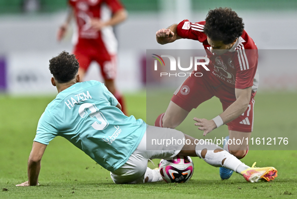 Hazem Ahmed Shehata (L) of Al Rayyan SC battles for the ball with Ahmed Alaaeildin Abdelmotaal (R) of Al Arabi SC during the Ooredoo Qatar S...