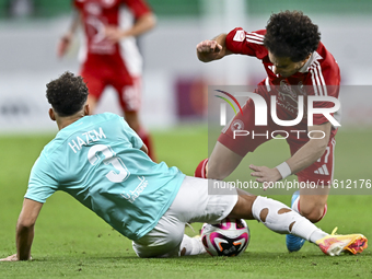 Hazem Ahmed Shehata (L) of Al Rayyan SC battles for the ball with Ahmed Alaaeildin Abdelmotaal (R) of Al Arabi SC during the Ooredoo Qatar S...