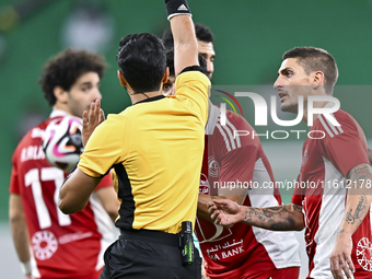 Qatari referee Abdulla Ali Athba gives a red card to Ahmed Alaaeildin Abdelmotaal (L) of Al Arabi SC during the Ooredoo Qatar Stars League 2...