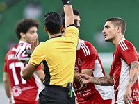 Qatari referee Abdulla Ali Athba gives a red card to Ahmed Alaaeildin Abdelmotaal (L) of Al Arabi SC during the Ooredoo Qatar Stars League 2...