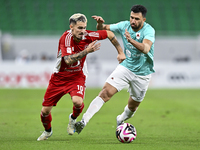 Mahmoud Hassan (R) of Al Rayyan SC battles for the ball with Rodriguez Sanchez Rodrigo (L) of Al Arabi SC during the Ooredoo Qatar Stars Lea...