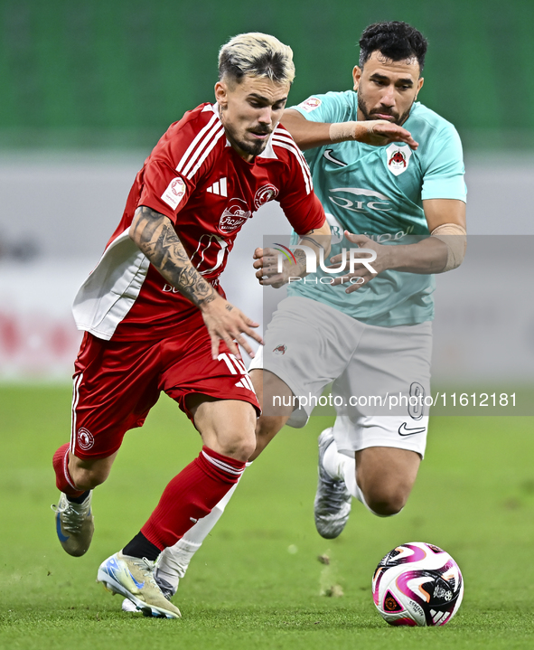 Mahmoud Hassan (R) of Al Rayyan SC battles for the ball with Rodriguez Sanchez Rodrigo (L) of Al Arabi SC during the Ooredoo Qatar Stars Lea...