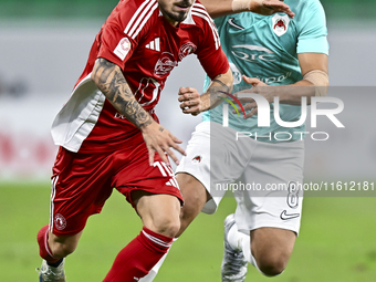 Mahmoud Hassan (R) of Al Rayyan SC battles for the ball with Rodriguez Sanchez Rodrigo (L) of Al Arabi SC during the Ooredoo Qatar Stars Lea...