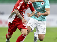 Mahmoud Hassan (R) of Al Rayyan SC battles for the ball with Rodriguez Sanchez Rodrigo (L) of Al Arabi SC during the Ooredoo Qatar Stars Lea...