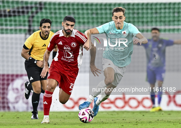 Julien De Sart (R) of Al Rayyan SC battles for the ball with Alaaeddin Mohammed Hasan (L) of Al Arabi SC during the Ooredoo Qatar Stars Leag...