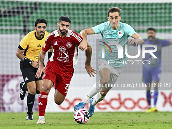 Julien De Sart (R) of Al Rayyan SC battles for the ball with Alaaeddin Mohammed Hasan (L) of Al Arabi SC during the Ooredoo Qatar Stars Leag...