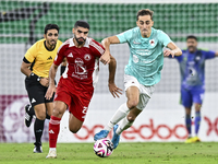 Julien De Sart (R) of Al Rayyan SC battles for the ball with Alaaeddin Mohammed Hasan (L) of Al Arabi SC during the Ooredoo Qatar Stars Leag...