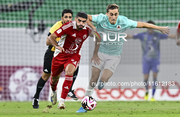 Julien De Sart (R) of Al Rayyan SC battles for the ball with Alaaeddin Mohammed Hasan (L) of Al Arabi SC during the Ooredoo Qatar Stars Leag...