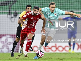 Julien De Sart (R) of Al Rayyan SC battles for the ball with Alaaeddin Mohammed Hasan (L) of Al Arabi SC during the Ooredoo Qatar Stars Leag...