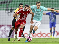 Julien De Sart (R) of Al Rayyan SC battles for the ball with Alaaeddin Mohammed Hasan (L) of Al Arabi SC during the Ooredoo Qatar Stars Leag...